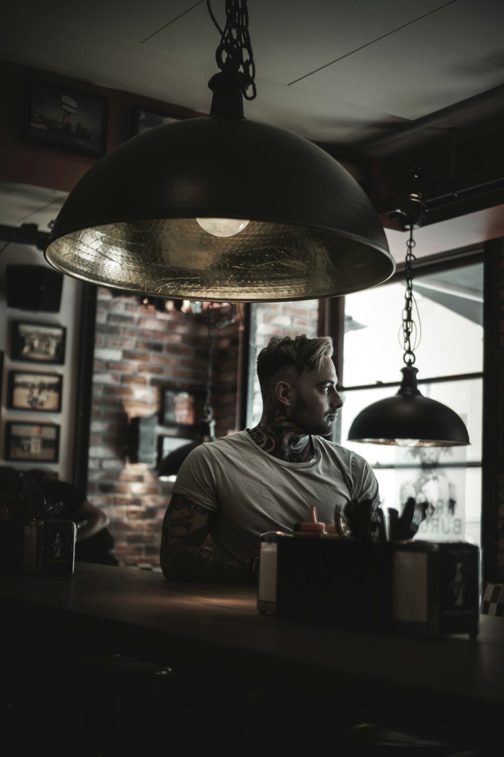 man sitting near pendant lamp