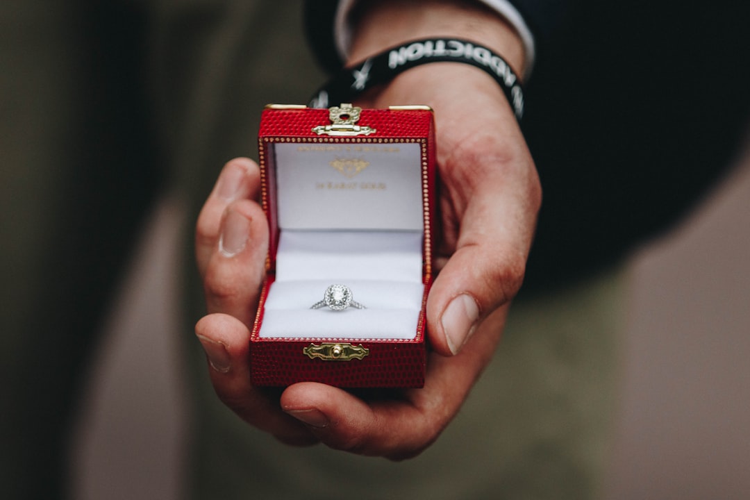 person holding box of silver-colored ring with clear gemstone, The Journey to Forever
