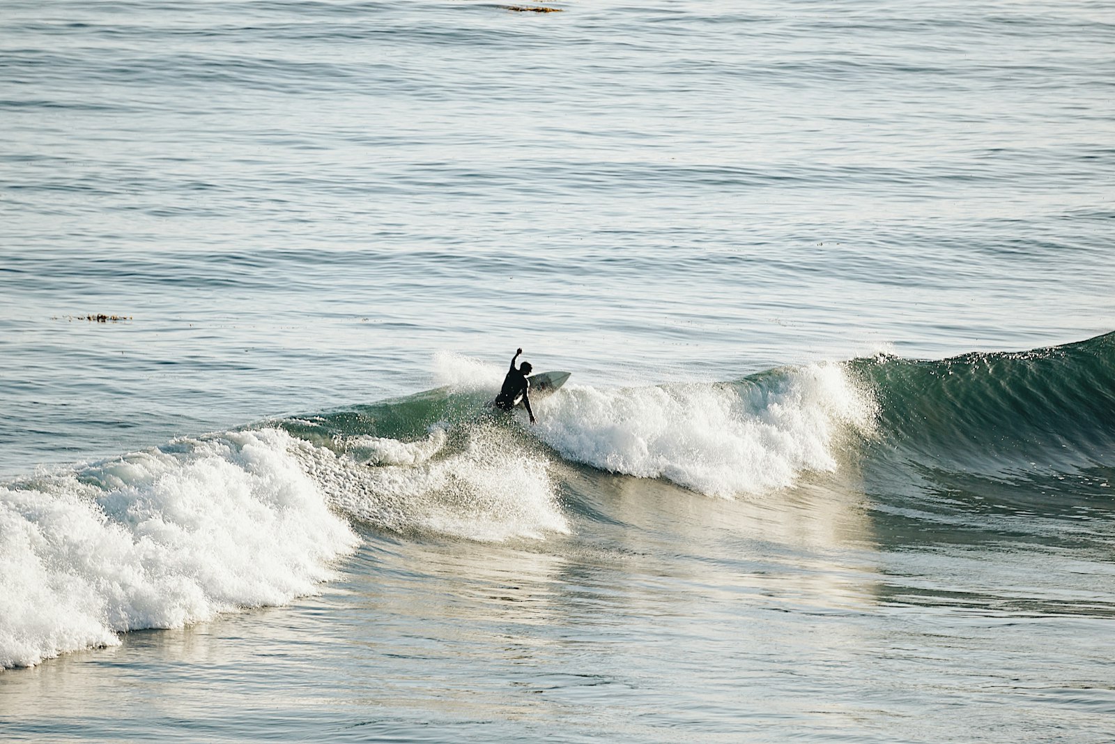 Sony E 55-210mm F4.5-6.3 OSS sample photo. Man surfing on waves photography