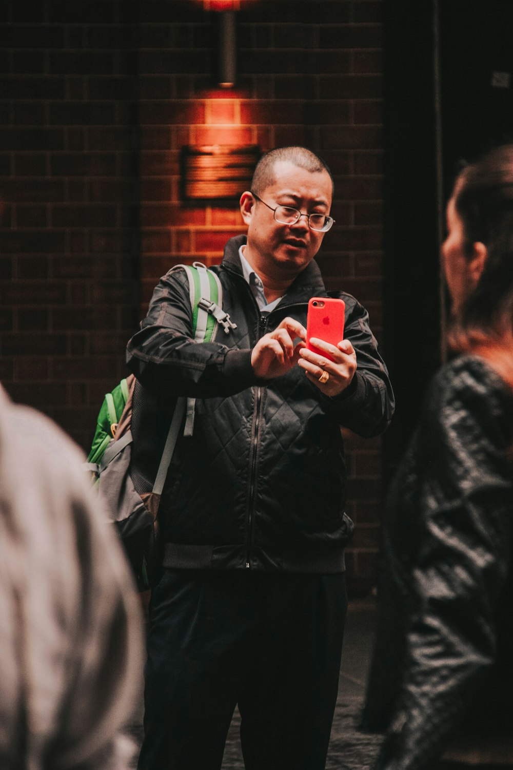 man holding iPhone outdoors