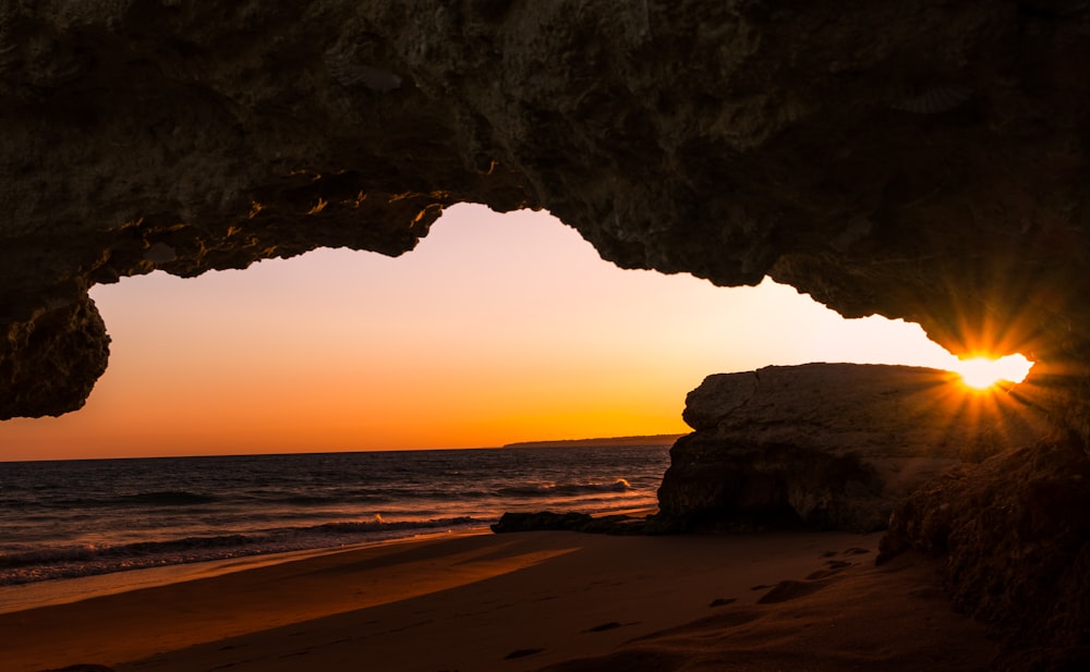 silhouette of rocky mountain on seashore