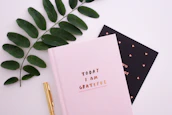 A calendar marked with daily gratitude notes and colorful stickers.