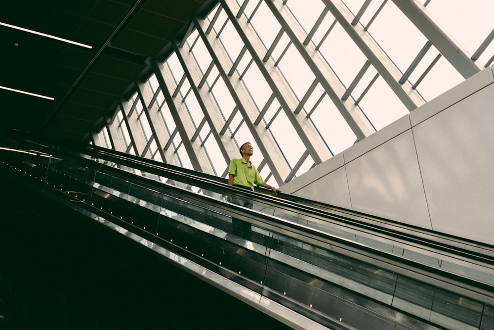 man riding escalator