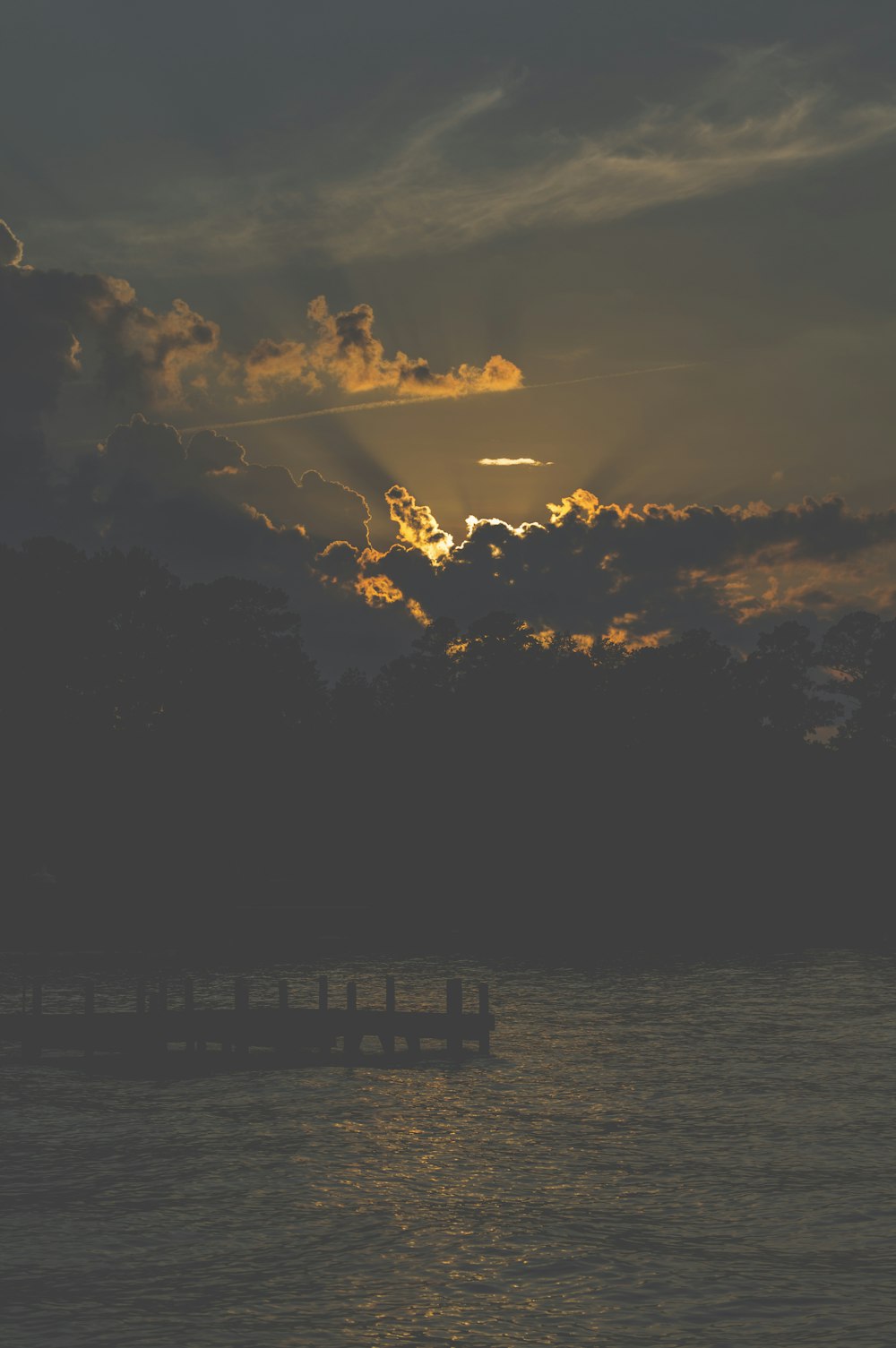 silhouette of dock during sunrise