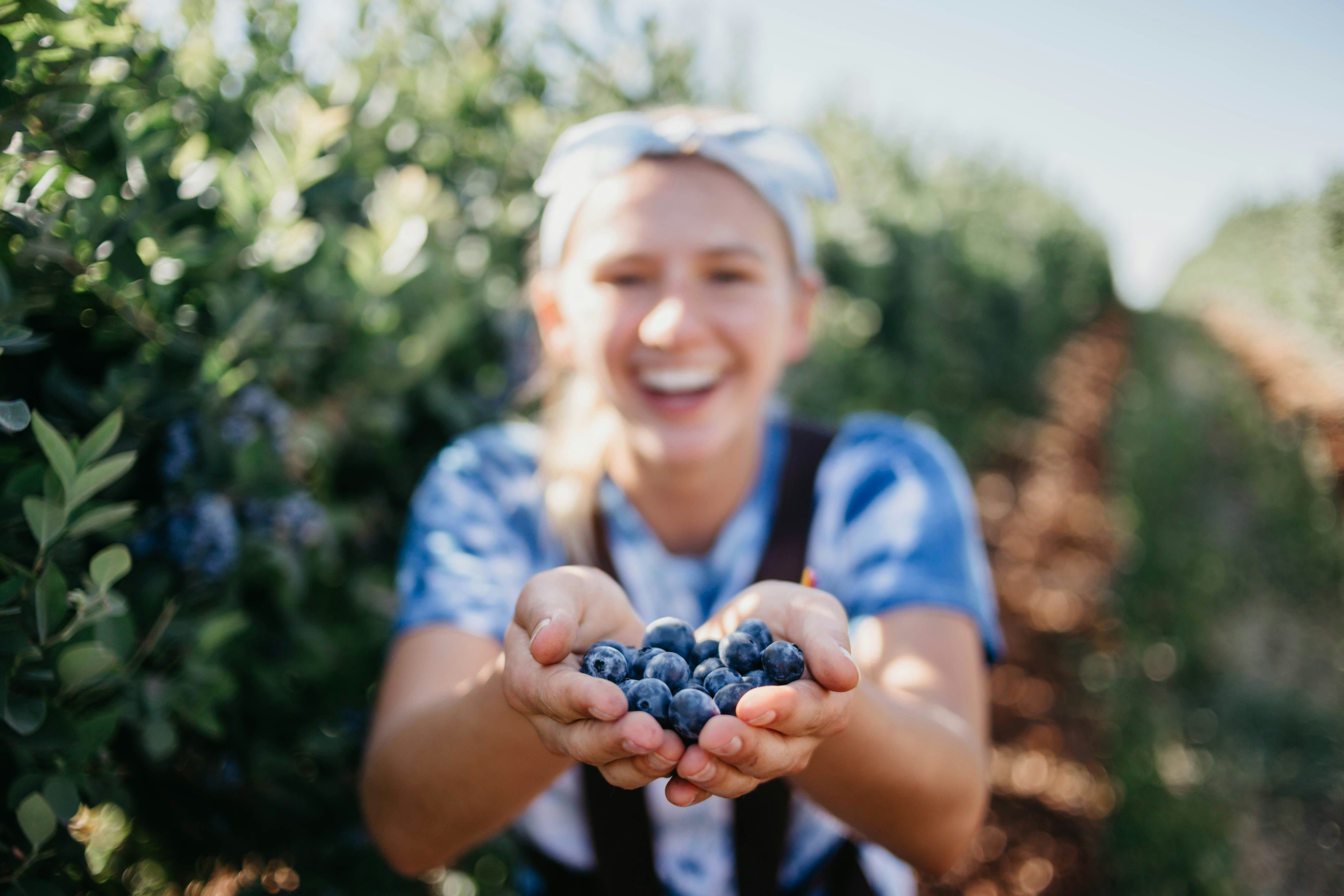 woman holding blueberries