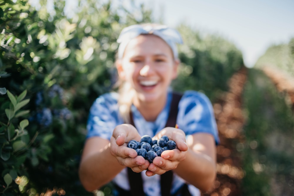 woman holding blueberries
