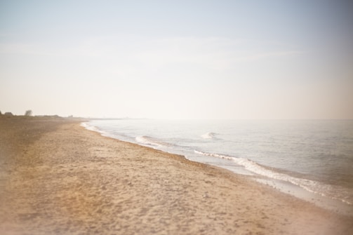 A serene coastal scene with gentle waves lapping on the shore.