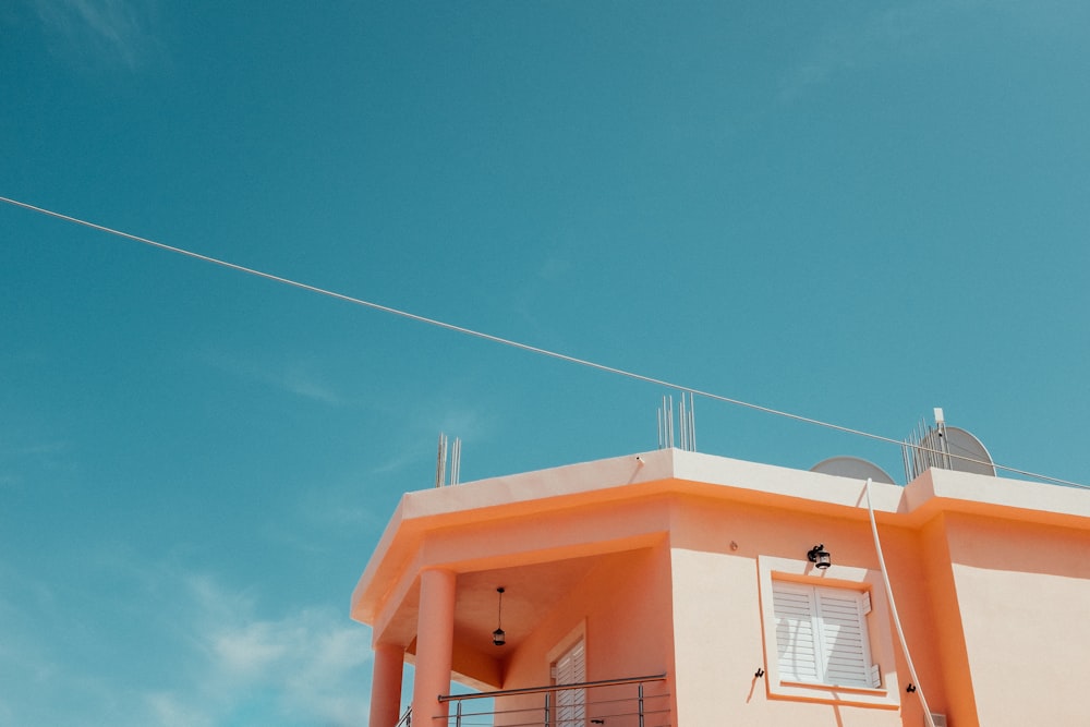 orange and white house under blue sky during daytime