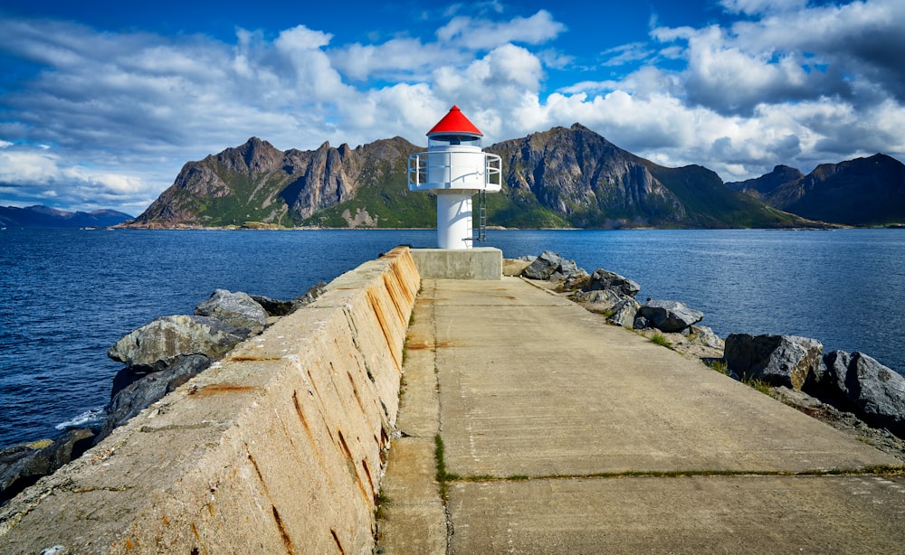 white light house near mountain