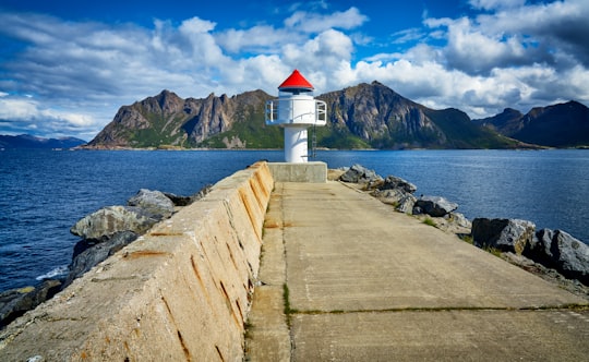 white light house near mountain in Hovden Norway