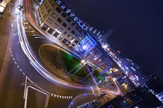 Close-up of a bounding box annotation highlighting vehicles on a busy urban street at dusk with neon reflections.
