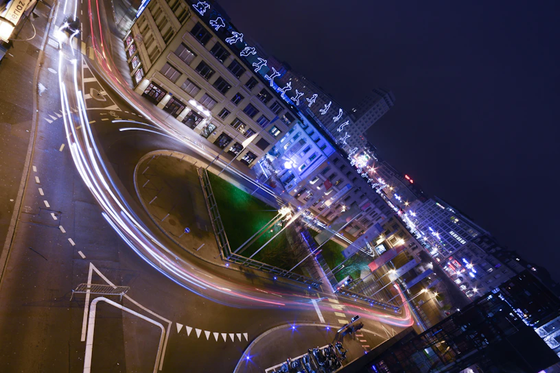 Close-up of a bounding box annotation highlighting vehicles on a busy urban street at dusk with neon reflections.