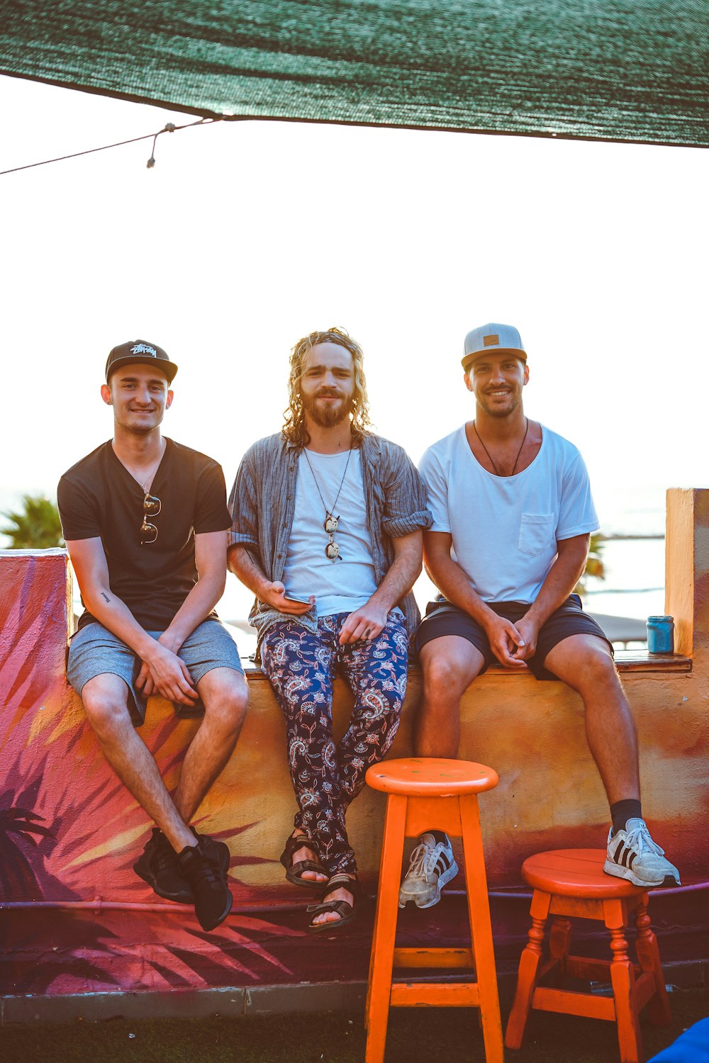 photography of three sitting men