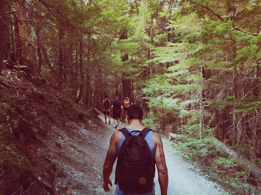 man wearing black backpack walk