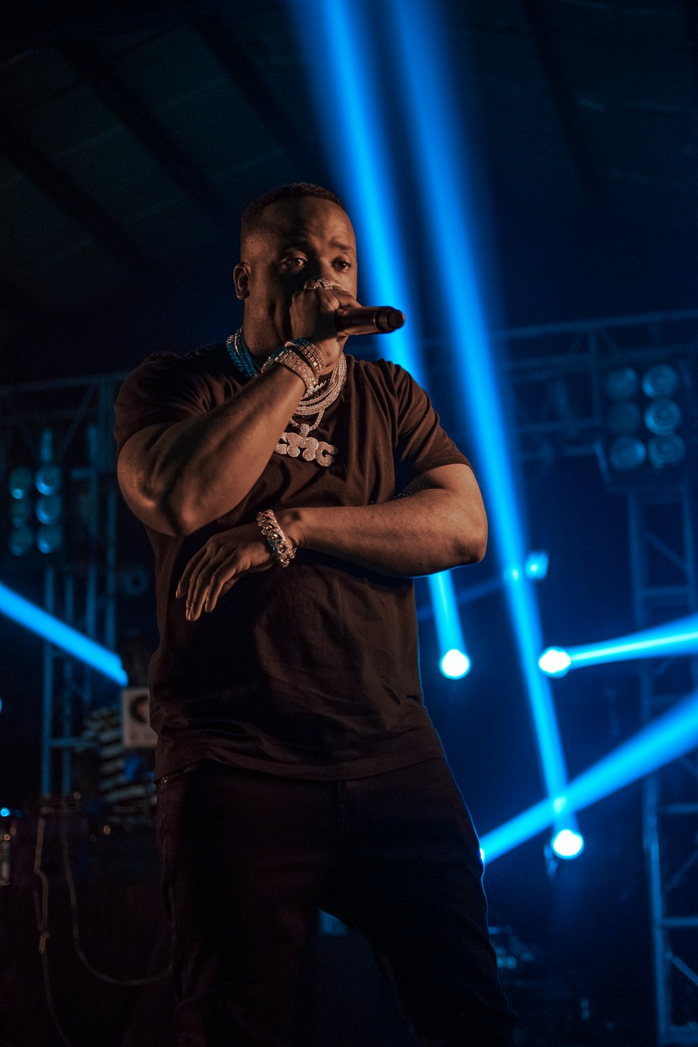 man holding microphone near spot lights