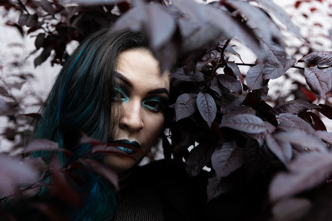 woman with green lipstick surrounded with plants