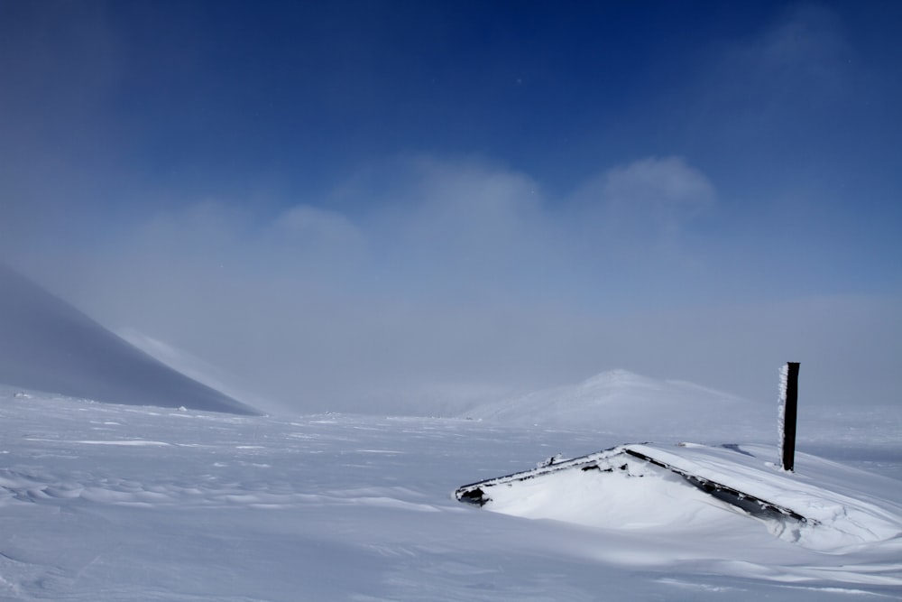 snow field under blue sky and white clouds