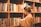 Happy male educator holding a book, standing in front of a bookshelf.
