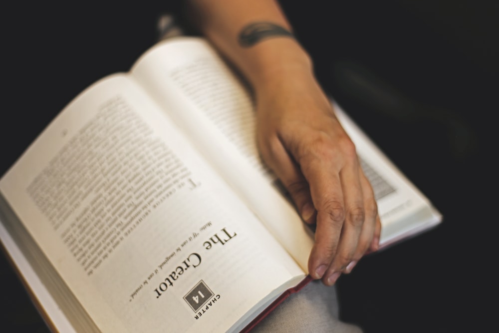 person holding The Creator book