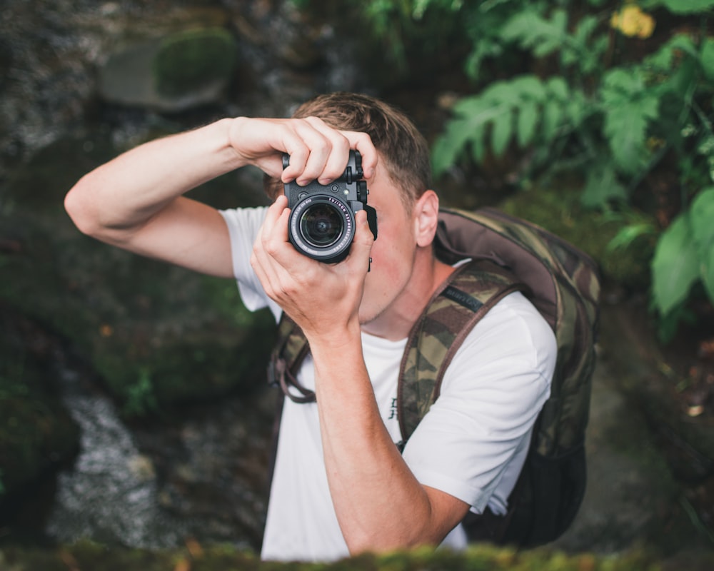 person using black DSLR camera