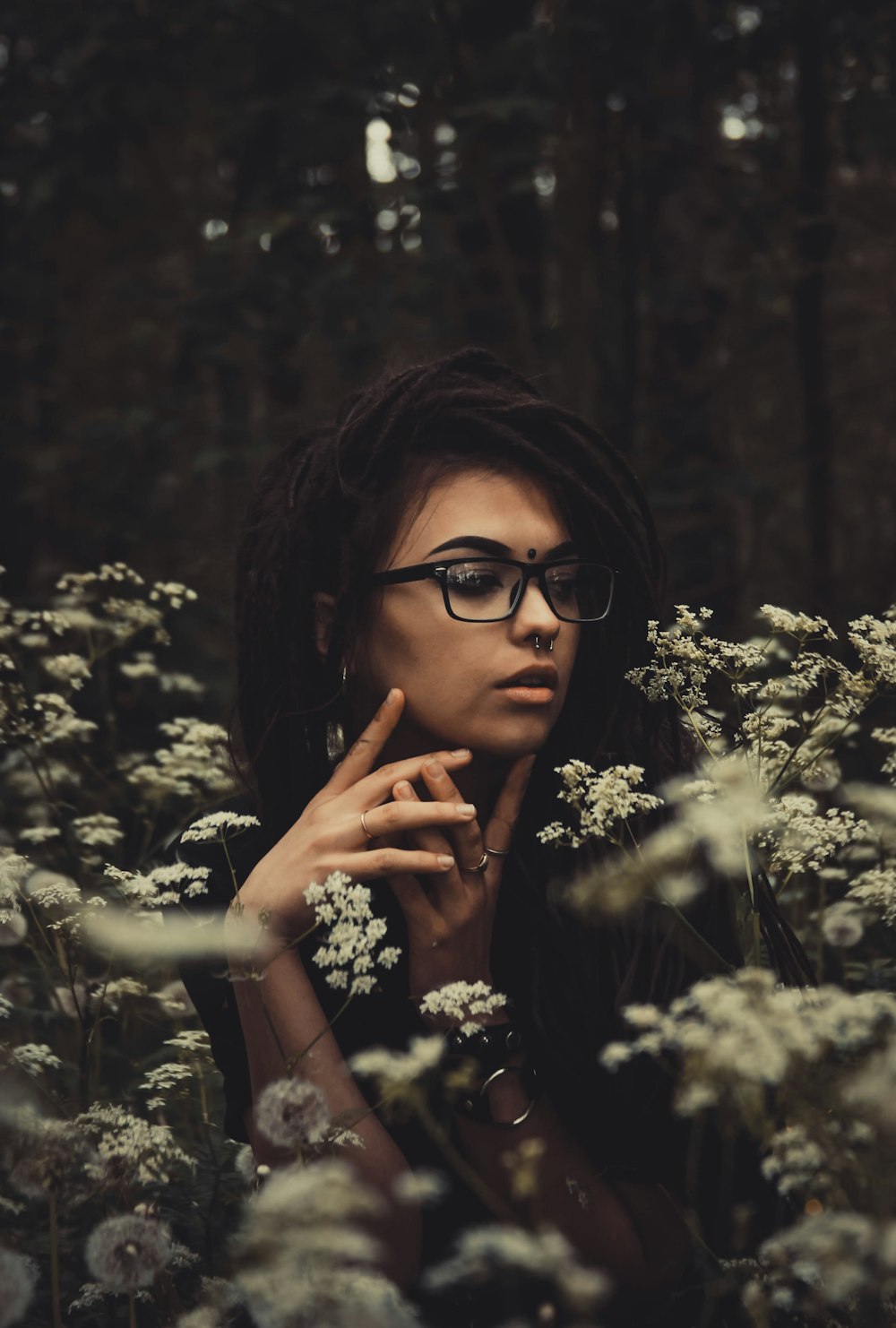 woman posing in middle of white flowers