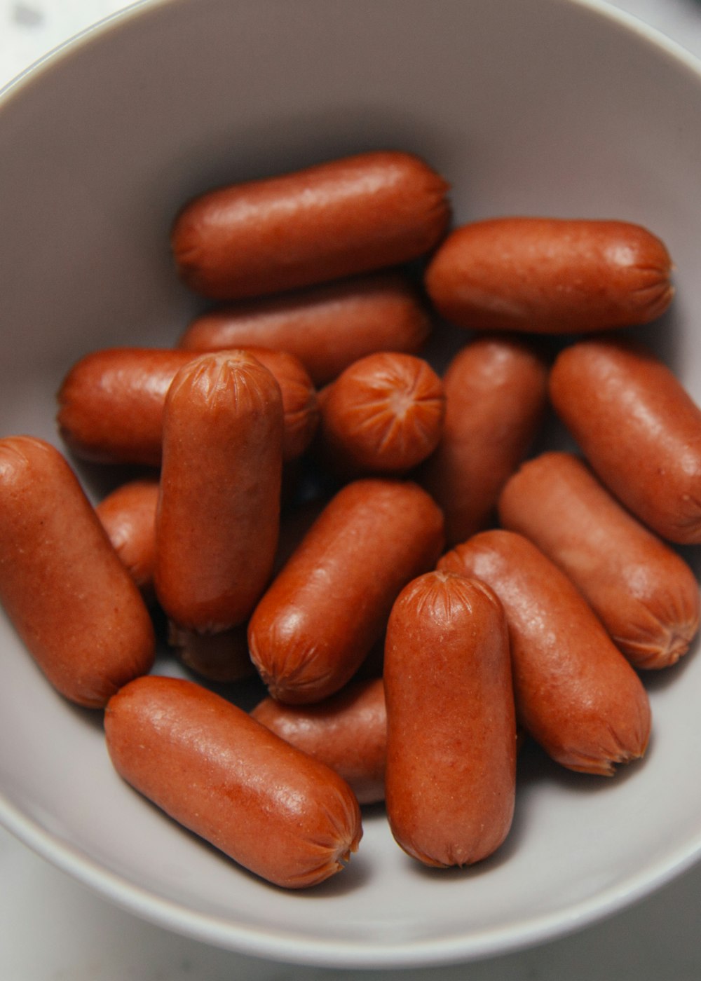 hotdogs in white ceramic bowl