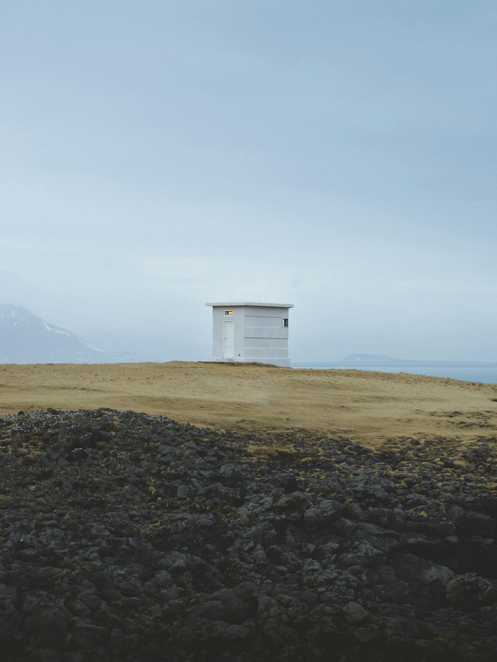 white wooden shed on top of hill