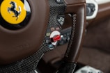brown and black Ferrari car steering wheel