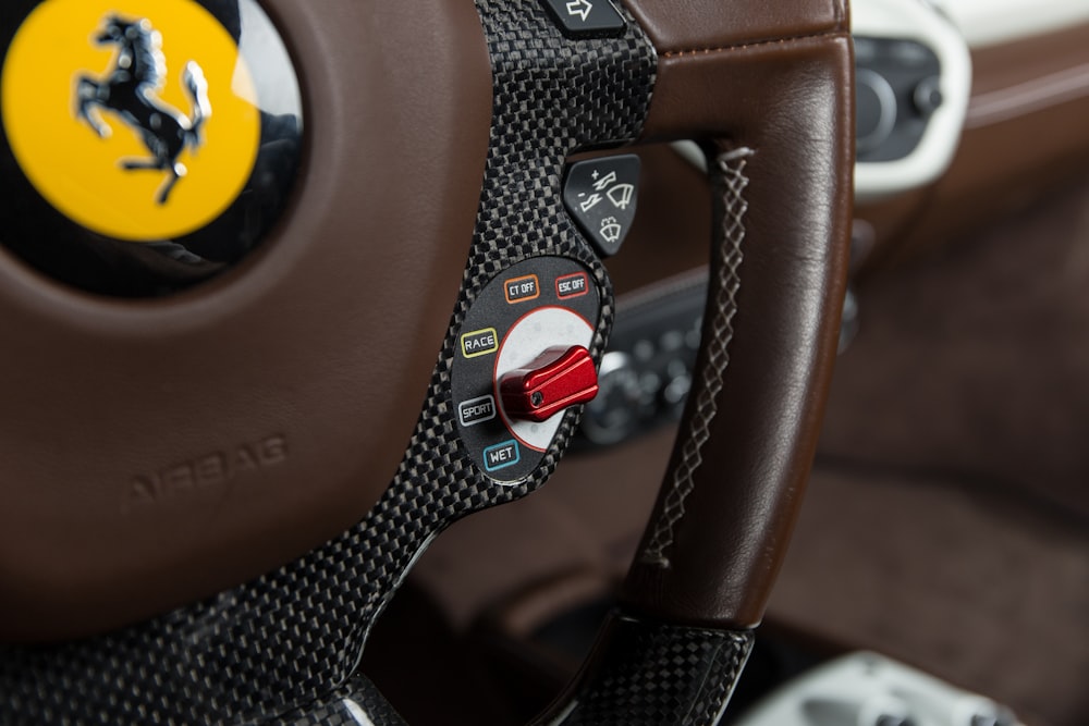 brown and black Ferrari car steering wheel