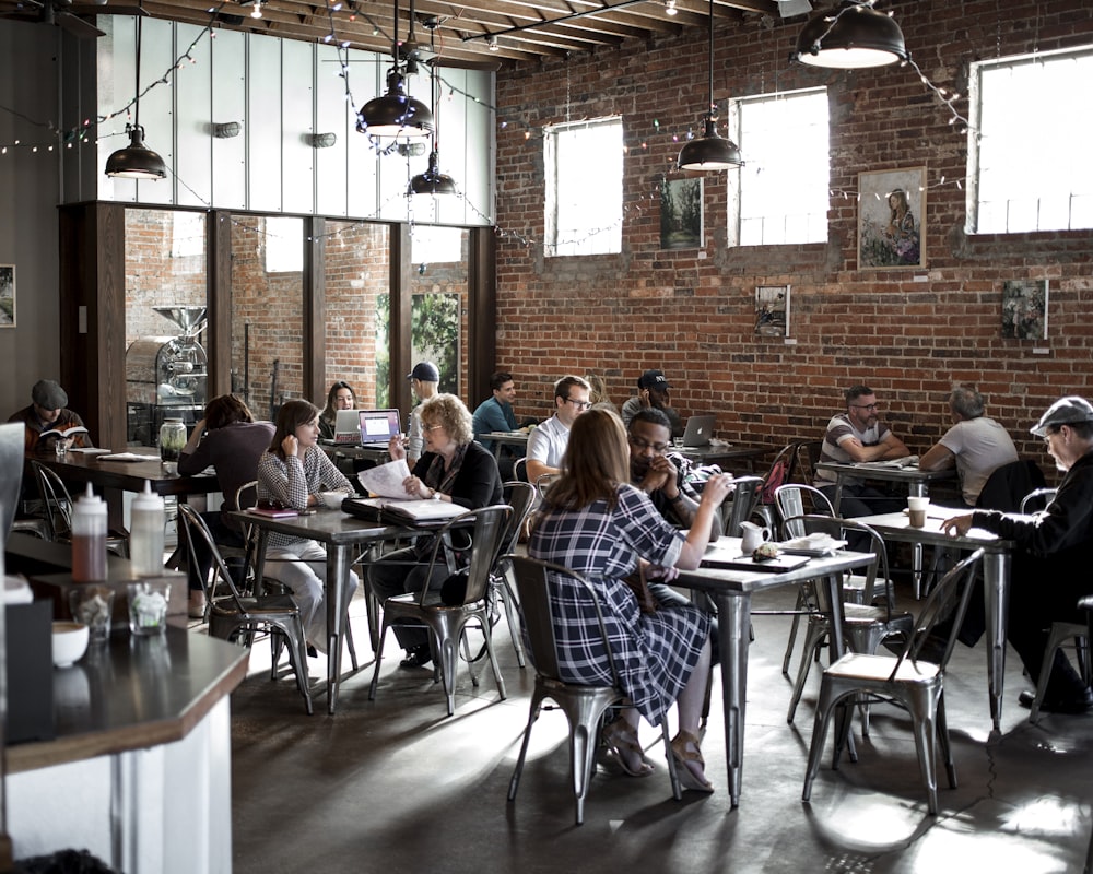 people sitting on restaurant chairs