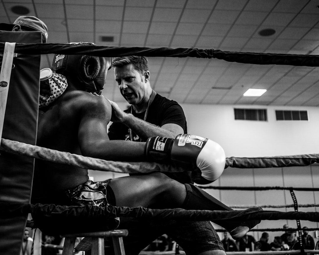  greyscale photography of a boxer inside reing match box