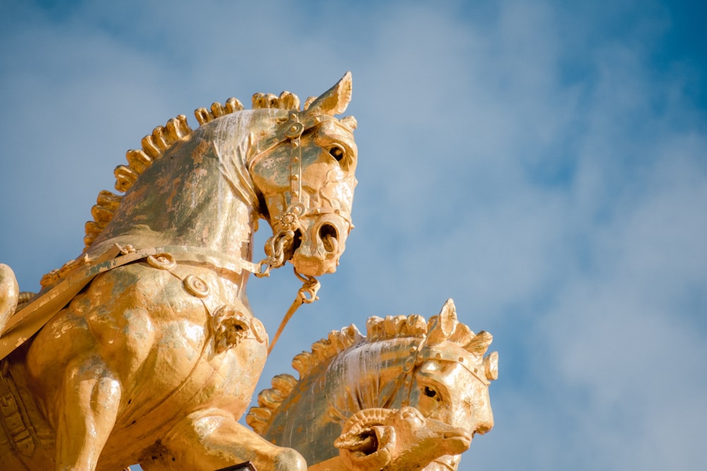 two gold horse statues