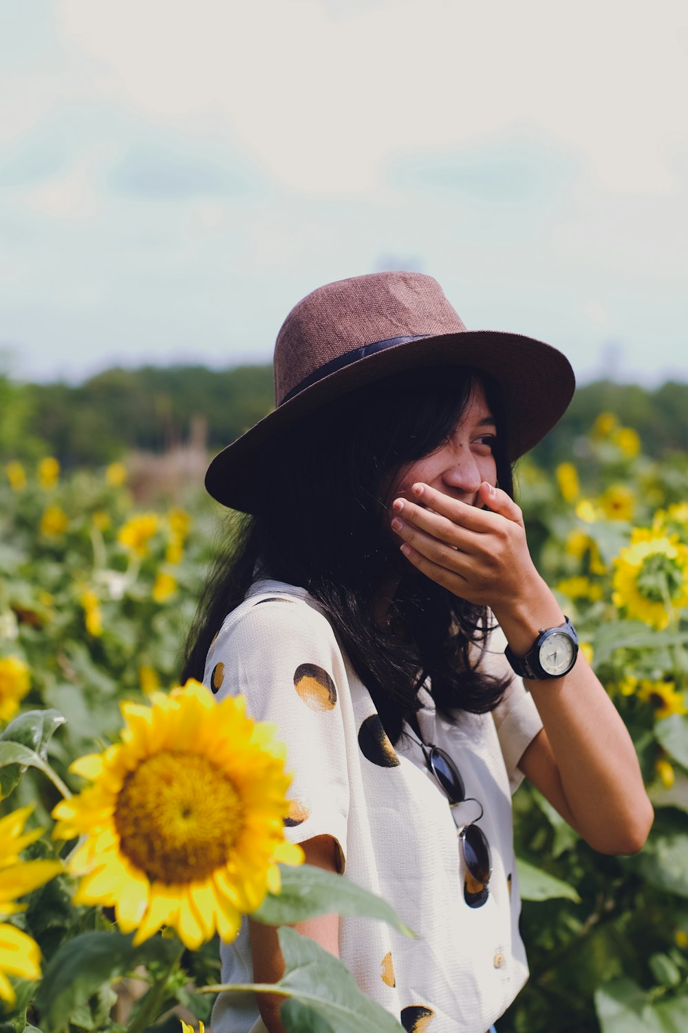 selective focus photography of woman between sunflowers