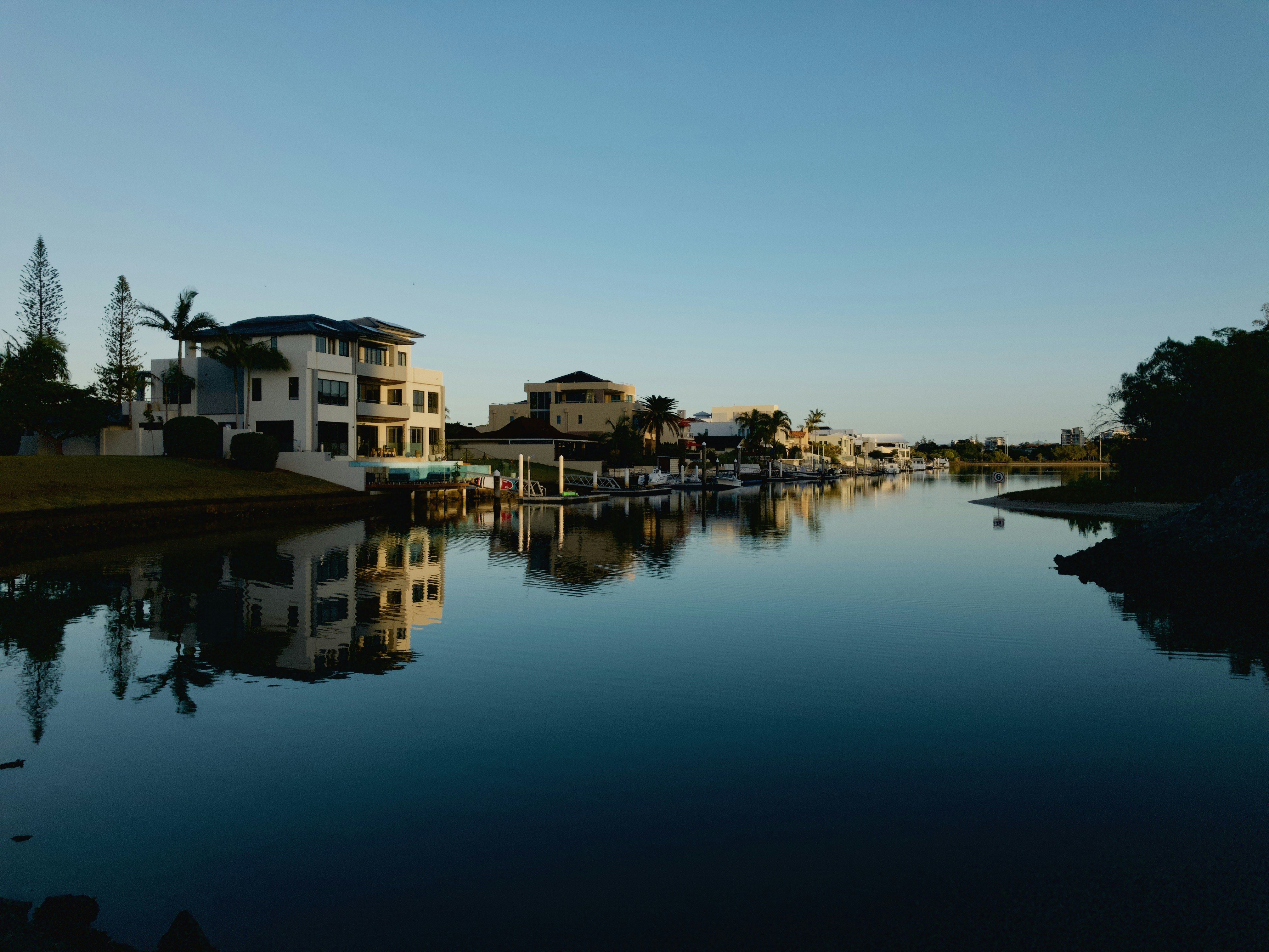 panoramic photography of white concrete house beside body of water