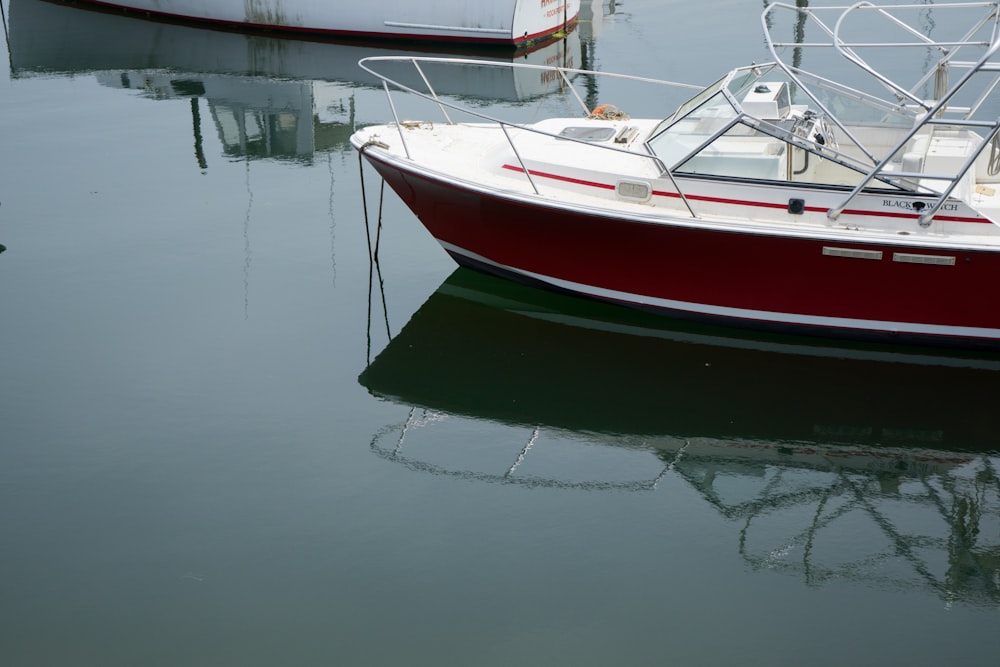 a red and white boat in a body of water