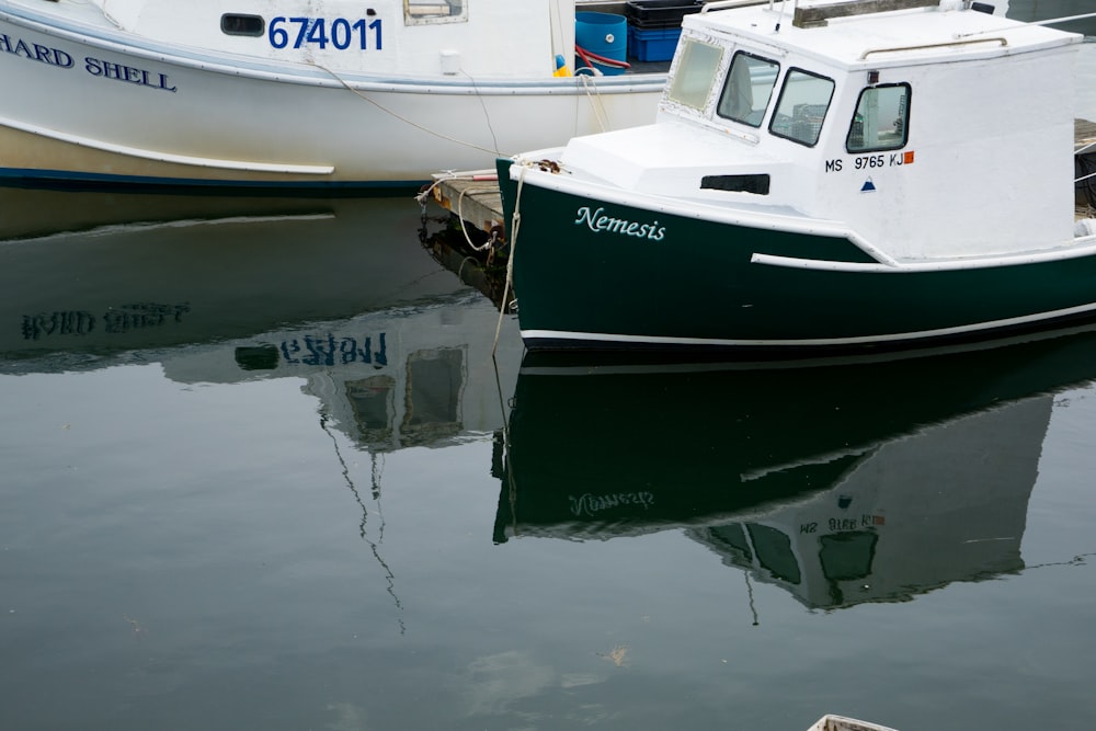 a small boat in the water next to a larger boat