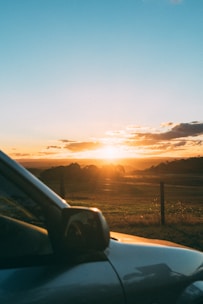 A serene landscape with a vehicle being towed away at sunset.