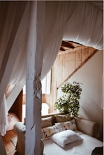 A cozy living room featuring cushions and curtains made from cotton blends.