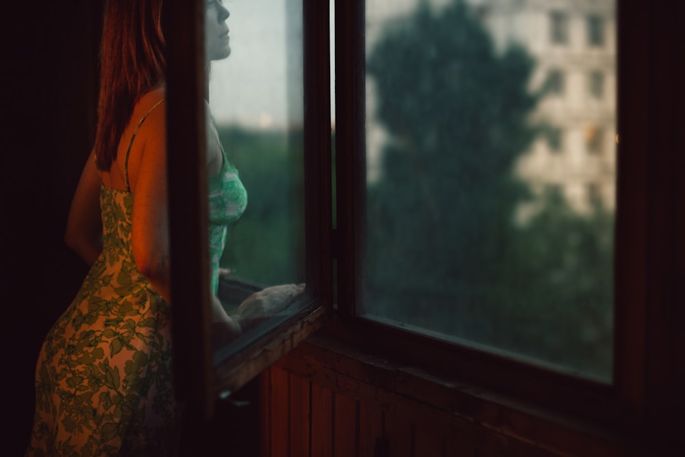 woman leaning on window