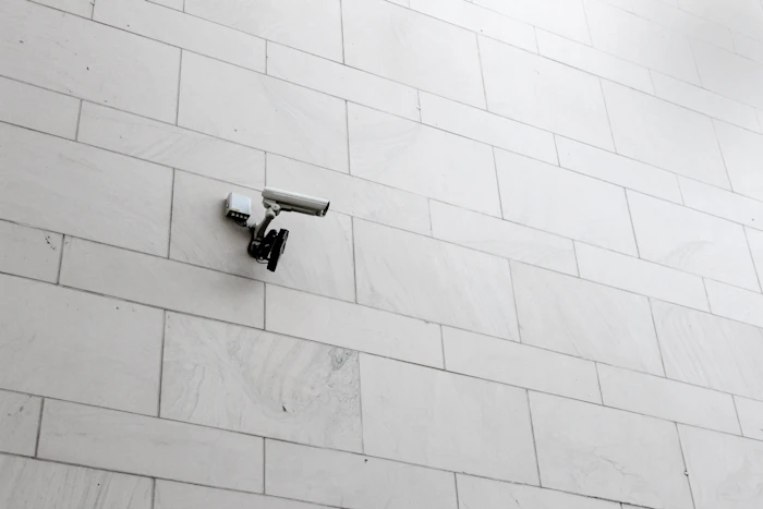 Grey surveillance camera on a wall