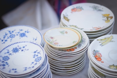 Stack of ceramic plates with vibrant patterns ready for serving.