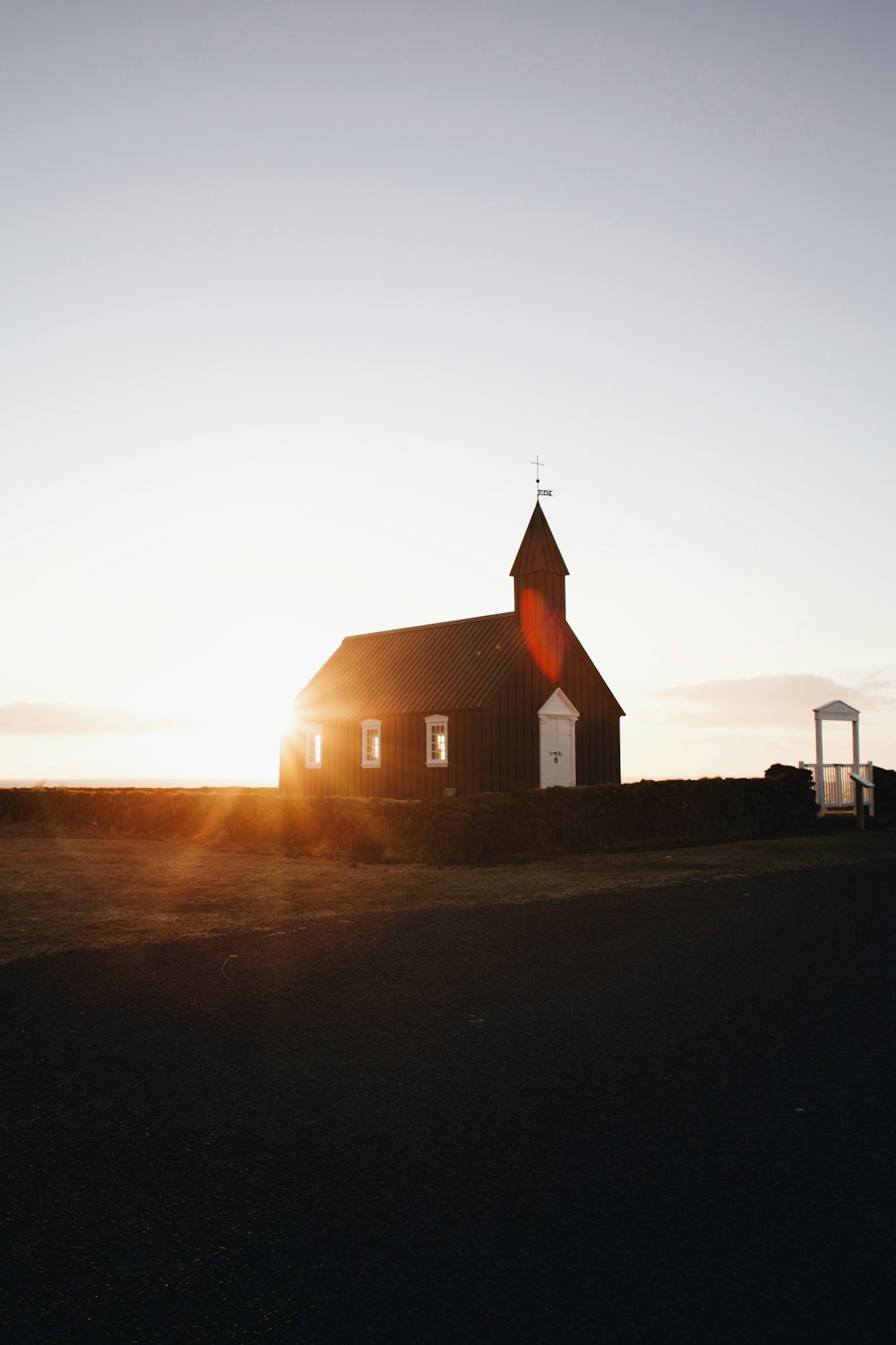 brown chapel surrounded green grass