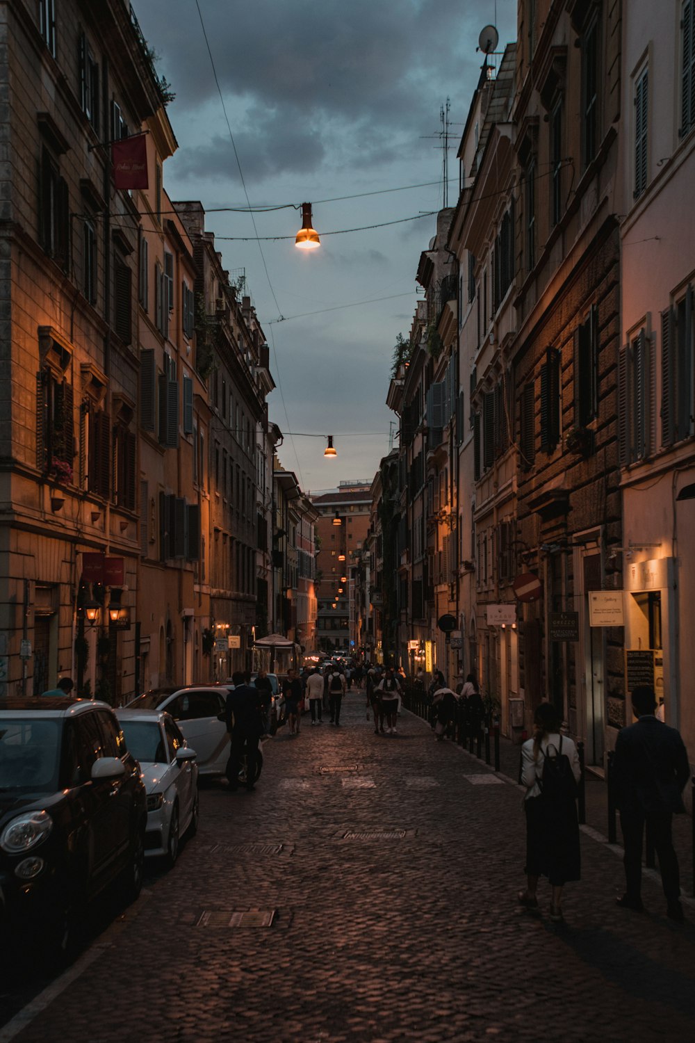 person walking between tall houses