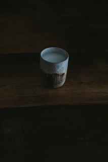 Table setting with spoilled milk stoneware plates, lit by warm afternoon light, evoking slow living