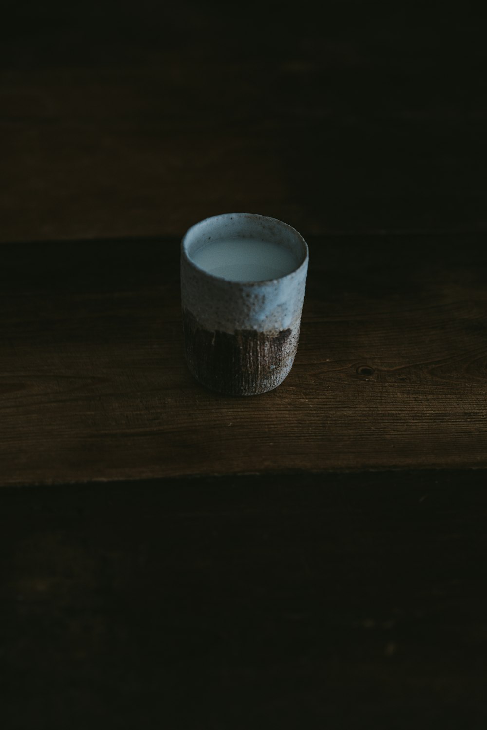 white and brown ceramic cup