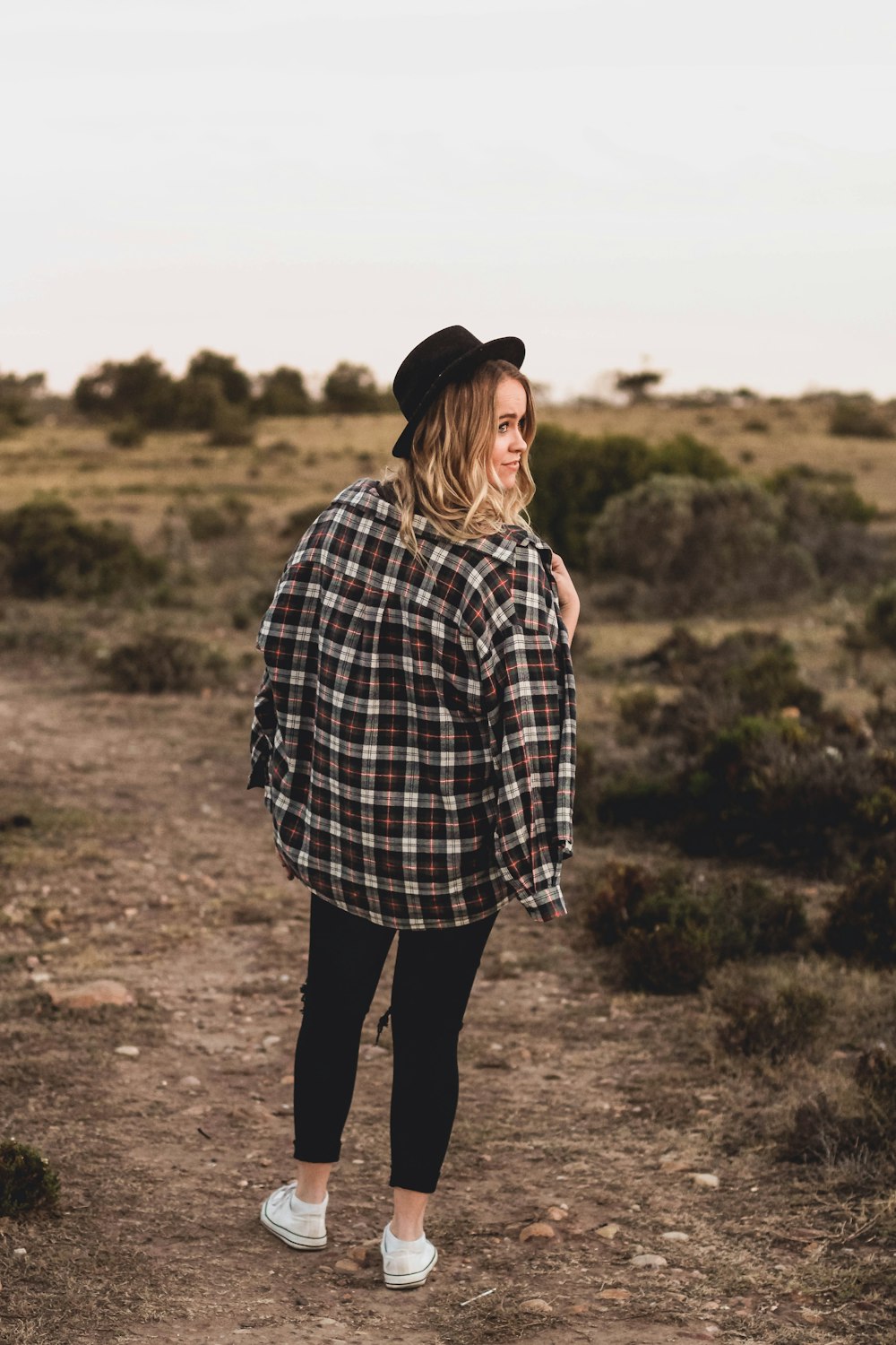 woman standing on brown soil