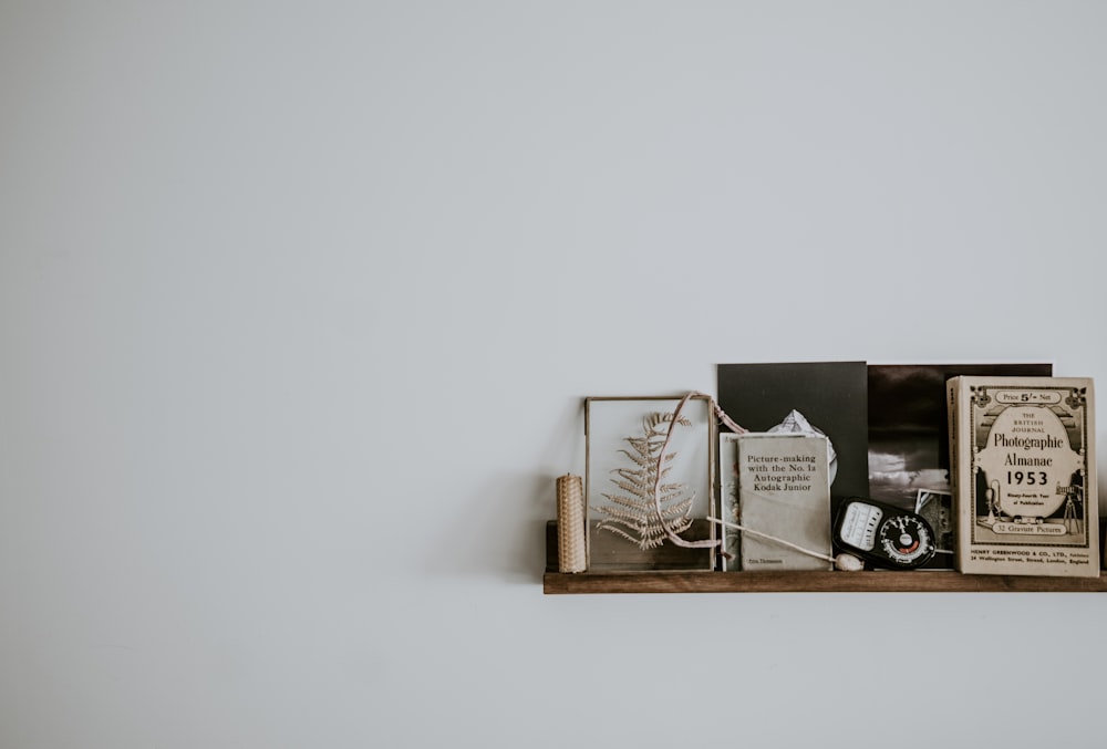 brown wooden floating shelf on white wall