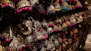 Artisan hands assembling a pair of feather earrings with intricate detail and care