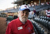 man wearing white and blue curve-brimmed cap