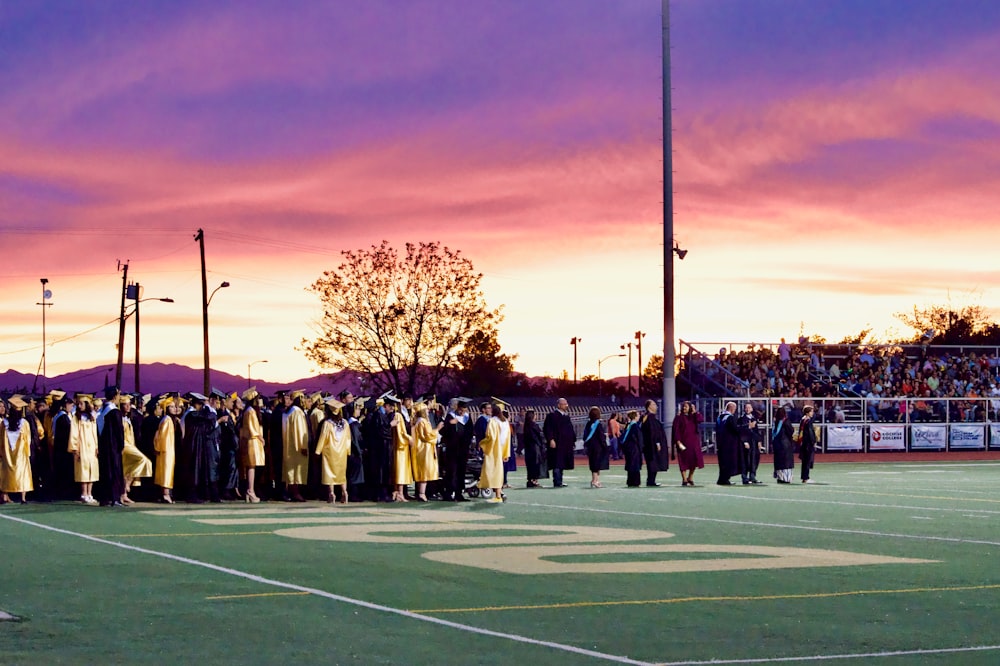 graduates gathered on football field